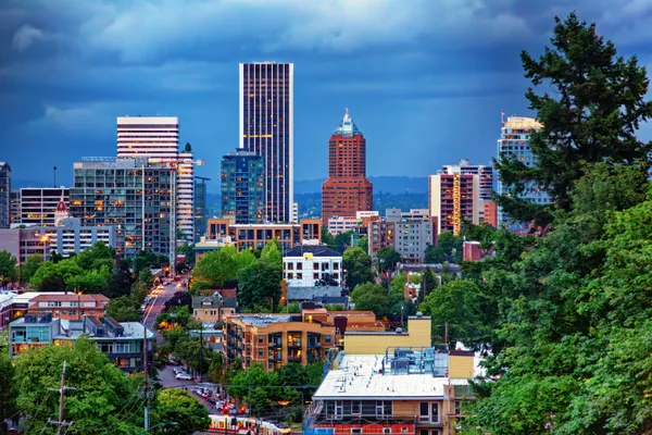 Near-hurricane force wind gusts persist across Portland-area neighborhoods, prompting travel cautions and scattered damage reports